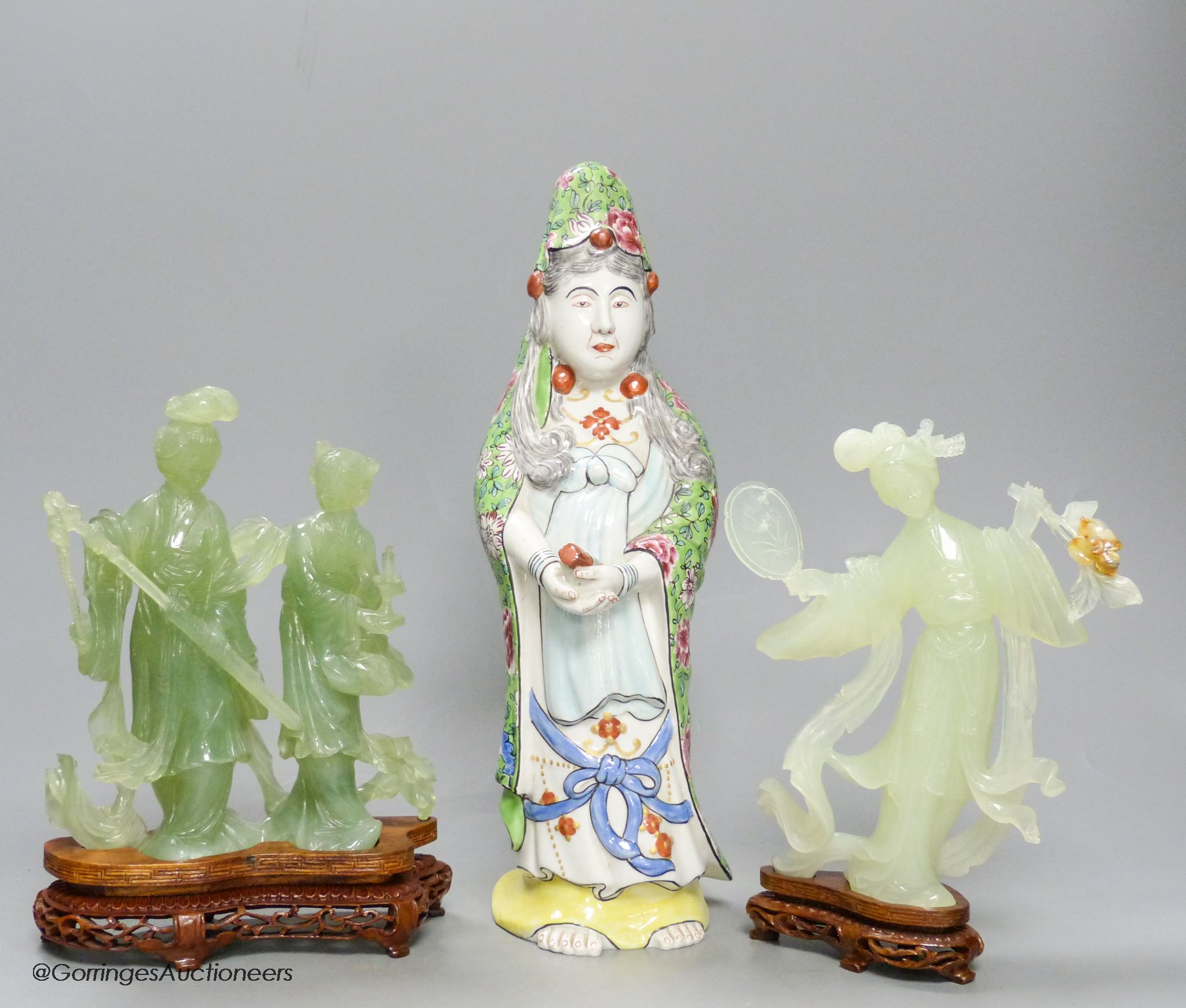 A pair of cased Chinese bowenite jade figure carvings and a porcelain figure of Guanyin, height 33cm
